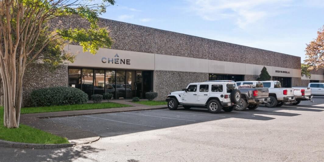 Property in Nonconnah Corporate Center being leased out by Chene; it's a brown building with Jeeps and trucks parked in front of it