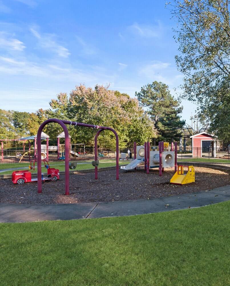 A children's playground with a swingset, a part of Nonconnah Corporate Center's park amenities
